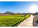 Scenic walking path with lush green spaces, connecting neighborhoods, and outdoor enjoyment at 26199 S 227Th St, Queen Creek, AZ 85142