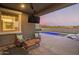 Inviting back patio with outdoor seating, TV, and a view of the sparkling pool at 28883 N 131St Dr, Peoria, AZ 85383