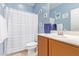 Well-lit bathroom with blue walls, white shower curtain, single sink vanity, and nautical decor at 28883 N 131St Dr, Peoria, AZ 85383