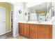 Bathroom boasts double sinks, wood cabinets, and a walk-in closet at 28883 N 131St Dr, Peoria, AZ 85383