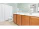 Bathroom showcasing a white shower curtain and wood vanity cabinet with a white counter and sink at 28883 N 131St Dr, Peoria, AZ 85383
