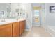 Bathroom features double sinks, wood cabinets, and a separate shower and tub at 28883 N 131St Dr, Peoria, AZ 85383