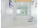 Bathroom highlighting a soaking tub with decorative accents and a bright window at 28883 N 131St Dr, Peoria, AZ 85383