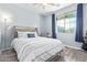Stylish bedroom featuring wood-look floors, modern decor, and a bright window at 28883 N 131St Dr, Peoria, AZ 85383