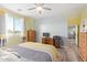Comfortable bedroom offers wood-look floors, a ceiling fan, and a built-in desk area at 28883 N 131St Dr, Peoria, AZ 85383