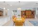 Open-concept dining area with a large table, chandelier lighting, and view of the kitchen at 28883 N 131St Dr, Peoria, AZ 85383