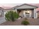 Inviting home exterior with rocking chairs on the front porch and a well-maintained yard at 28883 N 131St Dr, Peoria, AZ 85383