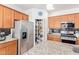 Modern kitchen with stainless steel refrigerator, granite countertops, and convenient pantry at 28883 N 131St Dr, Peoria, AZ 85383