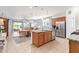 Open-concept kitchen with granite island, stainless steel appliances, and adjacent dining area at 28883 N 131St Dr, Peoria, AZ 85383