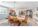 Open kitchen and dining area boasts wood cabinets, stainless appliances, and a stylish chandelier at 28883 N 131St Dr, Peoria, AZ 85383
