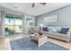 Comfortable living room with sliding glass doors to the backyard pool at 28883 N 131St Dr, Peoria, AZ 85383