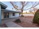 Cozy backyard with covered patio, desert landscaping, and mature trees at 2907 S Elm St, Tempe, AZ 85282