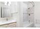 Bright bathroom featuring a tub with marble tile surround and a vanity with modern fixtures at 2907 S Elm St, Tempe, AZ 85282