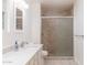 Bright bathroom features vanity with white countertops and tiled shower with glass door at 2907 S Elm St, Tempe, AZ 85282