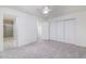 Bedroom featuring a ceiling fan, neutral carpet, an ensuite bathroom, and a closet at 2907 S Elm St, Tempe, AZ 85282