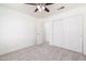 This bedroom features a ceiling fan, closet, and carpet flooring at 2907 S Elm St, Tempe, AZ 85282