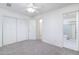 Bedroom featuring a ceiling fan, neutral carpet, and access to ensuite bathroom and closet at 2907 S Elm St, Tempe, AZ 85282