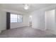 Bedroom featuring a ceiling fan, neutral carpet, and access to the ensuite bathroom at 2907 S Elm St, Tempe, AZ 85282