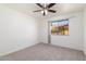 A cozy bedroom with a ceiling fan and a large window for plenty of natural light at 2907 S Elm St, Tempe, AZ 85282