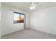 Bedroom featuring neutral carpet, ceiling fan, and a window offering natural light at 2907 S Elm St, Tempe, AZ 85282