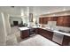 Bright kitchen features stainless steel appliances, stone backsplash, brown cabinets and lots of counter space at 2907 S Elm St, Tempe, AZ 85282