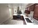Modern kitchen with stainless steel appliances, dark cabinets, white countertops and wood-look flooring at 2907 S Elm St, Tempe, AZ 85282