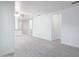 Spacious open-concept living room featuring gray laminate floors and bright white walls at 2907 S Elm St, Tempe, AZ 85282