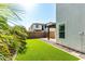 Low maintenance backyard with artificial grass, gravel beds and a covered patio at 3555 E Erie St, Gilbert, AZ 85295