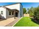 Private backyard featuring artificial grass, a covered patio, pavers and an easy-to-maintain landscape at 3555 E Erie St, Gilbert, AZ 85295