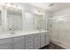 Well-lit bathroom featuring double sinks, modern fixtures, and a walk-in shower at 3555 E Erie St, Gilbert, AZ 85295