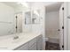 Bright bathroom featuring double mirrors, white vanity, and an adjacent toilet and tub at 3555 E Erie St, Gilbert, AZ 85295