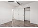 Bedroom features hardwood floors, a ceiling fan, and a closet with sliding doors at 3555 E Erie St, Gilbert, AZ 85295
