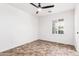 Well-lit bedroom with a ceiling fan, shuttered windows, and tile floors at 3555 E Erie St, Gilbert, AZ 85295