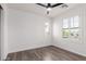 Bedroom features hardwood floors, a ceiling fan, and shuttered windows for natural light at 3555 E Erie St, Gilbert, AZ 85295