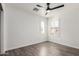 Inviting bedroom with wood-look floors, white walls, and a ceiling fan for added comfort at 3555 E Erie St, Gilbert, AZ 85295