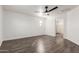 Spacious bedroom with wood floors, ceiling fan, neutral colors, and ensuite bathroom at 3555 E Erie St, Gilbert, AZ 85295