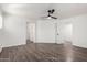 Bright bedroom with wood floors, ceiling fan, and multiple doorways at 3555 E Erie St, Gilbert, AZ 85295
