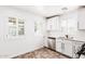 Well-lit kitchen area featuring stainless appliances, white cabinetry, and tiled floors at 3555 E Erie St, Gilbert, AZ 85295