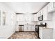 Modern kitchen with white cabinets, stainless steel appliances, and tile flooring at 3555 E Erie St, Gilbert, AZ 85295