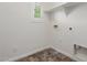 Functional laundry room featuring a window, shelving, and connections for a washer and dryer at 3555 E Erie St, Gilbert, AZ 85295