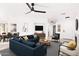 Open-concept living room with modern furnishings, stylish ceiling fan, and ample natural light at 3555 E Erie St, Gilbert, AZ 85295