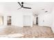 Bright living room with a ceiling fan, tile floors, and an open floor plan at 3555 E Erie St, Gilbert, AZ 85295