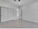 A bright bedroom with a sliding closet door, white walls, and wood-look tile flooring at 36321 N 16Th St, Phoenix, AZ 85086