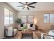 Bright living room features comfortable seating, a ceiling fan, and large windows, creating a warm atmosphere at 3747 W Memorial Dr, Phoenix, AZ 85086