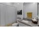 Clean bathroom with granite vanity, framed mirror, and shower with striped curtain at 4020 E Toledo St # 103, Gilbert, AZ 85295