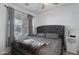 Bedroom with large window with grey comforter and ceiling fan at 4020 E Toledo St # 103, Gilbert, AZ 85295