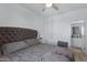 Bedroom with large bed with gray comforter, ceiling fan and attached bath at 4020 E Toledo St # 103, Gilbert, AZ 85295