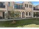 Attractive townhome showcases a balcony, welcoming entrance, and lush green space at 4020 E Toledo St # 103, Gilbert, AZ 85295