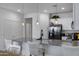 Bright kitchen with granite countertops, a black stainless refrigerator, and modern pendant lighting at 4020 E Toledo St # 103, Gilbert, AZ 85295