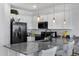 Stylish kitchen features granite countertops, stainless steel appliances and sleek white cabinetry at 4020 E Toledo St # 103, Gilbert, AZ 85295